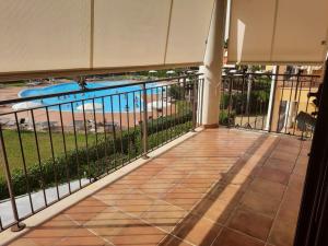 a balcony with a view of a swimming pool at Dimora sul mare in Policoro