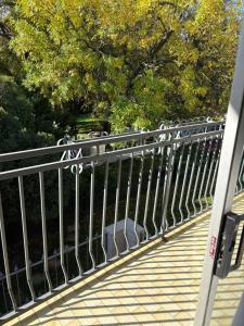 a metal railing on a bridge with trees in the background at Cloete Self Catering Sky Room in Ermelo