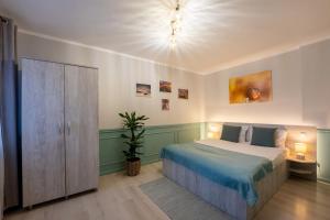 a bedroom with a bed and a chandelier at Smart Apartments Central in Sighişoara