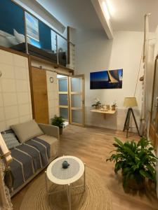 a living room with a couch and a table at la passerelle du couchant in Langlade