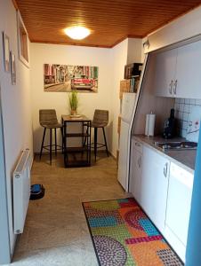 a kitchen with a table and chairs in a room at SeeSternchen in Faak am See