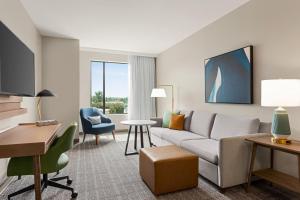 a living room with a couch and a table at Staybridge Suites Rockford by IHG in Rockford