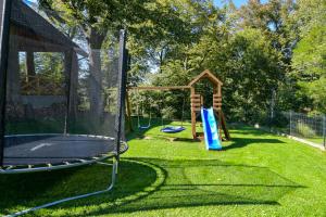 a park with a playground with a trampoline at Apartamenty Tilia Laskowa - Zator in Laskowa