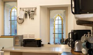 a kitchen with two stained glass windows and a counter at St Michaels Lodge in Richmond
