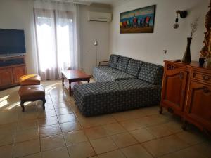a living room with a couch and a table at Maison classée 3étoiles proche plage in Mauguio +19 photos