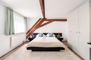 a bedroom with white walls and a large bed at Buhlsche Mühle in Ettlingen