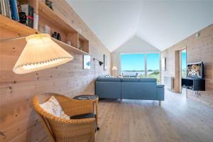 a living room with a blue couch and a tv at 702-Hvide-Sande-Slusen-2 in Hvide Sande