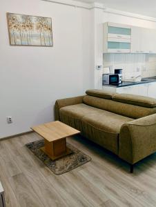 a living room with a couch and a table at FLH - Apartament Central Silva in Sibiu +10 photos