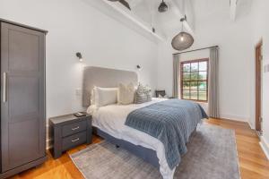 a bedroom with a large bed and a window at Millstream manor guest house in Robertson +18 photos