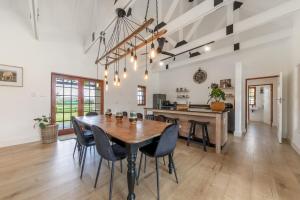 a kitchen and dining room with a wooden table and chairs at Millstream manor guest house in Robertson