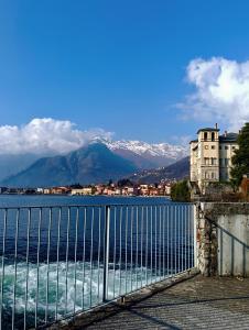 a view of the water with mountains in the background at Lake Como PORTO VECCHIO - Charming Lakefront Apartment in the Heart of Domaso in Domaso