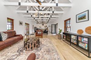 a living room with a couch and a table at Millstream manor guest house in Robertson