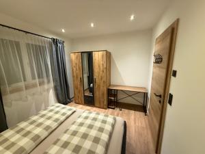 a bedroom with a bed and a wooden cabinet at Appartement Bergsicht in Leogang