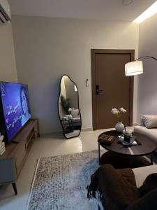 a living room with a couch and a mirror at ZA apartment in Al Ahsa