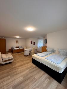 a bedroom with two beds and a living room at Ferienapartment Lidia in Kastellaun