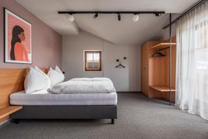 a bedroom with a bed and a window at Julius Appartements & Zimmer in Wagrain +138 photos