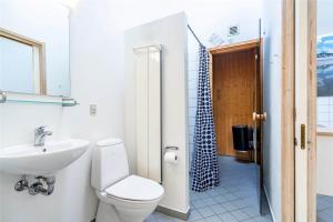 a bathroom with a toilet and a sink and a shower at 712-Hvide-Sande-Slusen-12 in Hvide Sande +22 photos