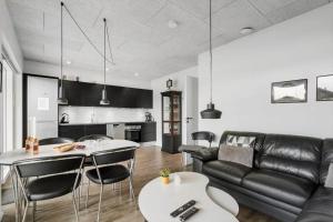 a living room with a couch and a table at 9928-Hvide-Sande-Langsand-86 in Hvide Sande