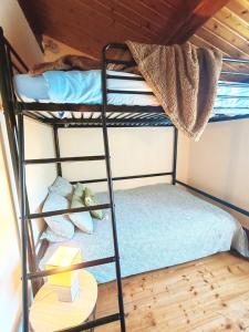 a bunk bed with a teddy bear on the bottom bunk at Maison proche plage et commodités in Meschers-sur-Gironde