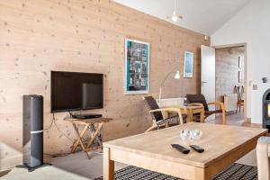 a living room with a television and a table at 718-Hvide-Sande-Slusen-18 in Hvide Sande