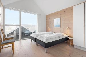 a bedroom with a bed and a large window at 718-Hvide-Sande-Slusen-18 in Hvide Sande