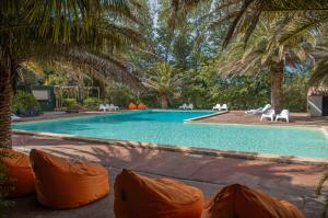 a swimming pool with a bunch of chairs around it at Camping la Peiriere - Chalet & Mobile-home in Tuchan