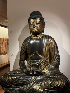 a bronze buddha statue in a museum at Amélia HOST chambre climatisée in Saint-Rémy-lès-Chevreuse