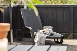 a blanket sitting on a chair on a patio at 6606-Hvide-Sande-Arvidvej-164 in Bjerregård +26 photos