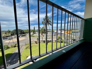a balcony with a view of a street and palm trees at 2Bedroom Apartment in Pinetown