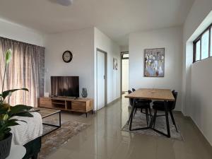 a living room with a table and a television at 2Bedroom Apartment in Pinetown