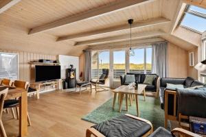 a living room with a couch and a table at 3395-Hvide-Sande-Fyrmarken-33 in Hvide Sande