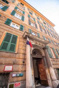 a building with a flag in front of it at Assarotti Luxury Suite in Genoa