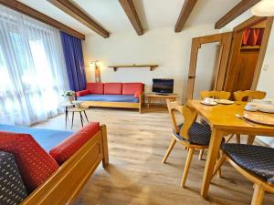 a living room with a couch and a table at Alpenlandhof in Bad Kleinkirchheim +151 photos