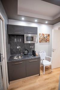 a kitchen with a sink and a microwave at Assarotti Luxury Suite in Genoa
