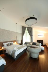 a bedroom with a bed and a couch and a chair at Terme BANJA LUKA in Banja Luka +27 photos