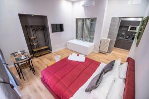 a bedroom with a red bed in a room at Assarotti Luxury Suite in Genoa