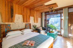 a bedroom with a bed with two flip flops on it at Sunlit Snow Mountain Z Naxi Ethnic Style Courtyard in Lijiang +17 photos