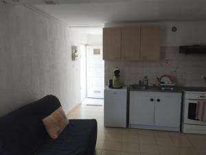 a kitchen with a couch in a small room at L' amandier in Teyran