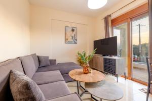 a living room with a couch and a tv at LuckyWoodyApartment in (( Kermetés ))