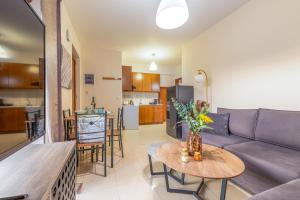 a living room with a couch and a table at LuckyWoodyApartment in (( Kermetés )) +9 photos