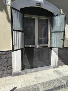 an entrance to a building with a black door at La Nica in Catania