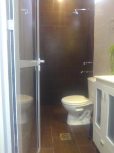 a bathroom with a toilet and a glass shower at Killa wasy in Humahuaca