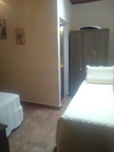 a bedroom with a bed and a cabinet in a room at Killa wasy in Humahuaca