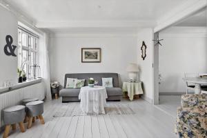 a living room with a couch and a table at 4221-Stege-Langgade-21 in Stege