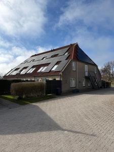 a large house with a lot of solar panels on it at Appartementenhotel Tjermelân Terschelling in Oosterend