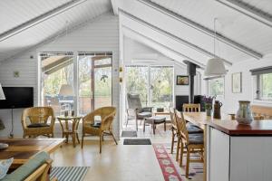 a kitchen and dining room with a table and chairs at 3054-Stege-Stejlepladsen-12 in Stege