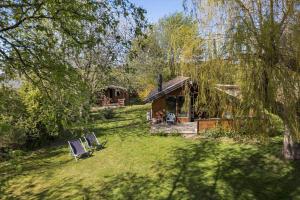 a cabin in a yard with two chairs in the grass at 3054-Stege-Stejlepladsen-12 in Stege