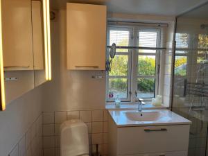 a small bathroom with a sink and a window at 6306-Stege-Hjelmvej-24 in Stege +22 photos