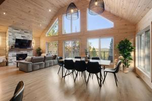 a large living room with a table and chairs at Chalet Le Solem Golf et Spa in Saint-Faustin +43 photos