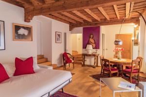 a living room with a bed and a table at Como Prestige Centro Apartment By Icon7 Luxury in Como